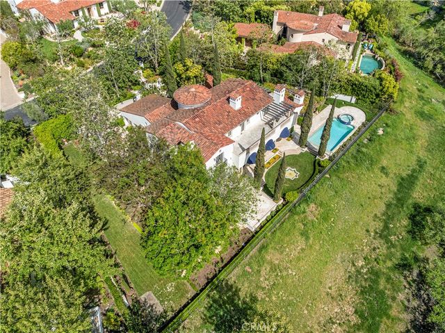 an aerial view of a residential houses with yard