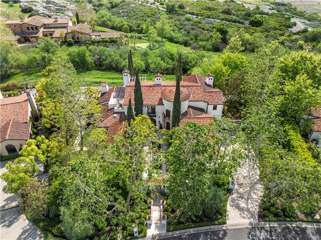 an aerial view of a house with yard