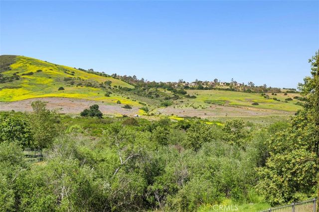a bathroom with a granite countertop toilet a sink and a mirror
