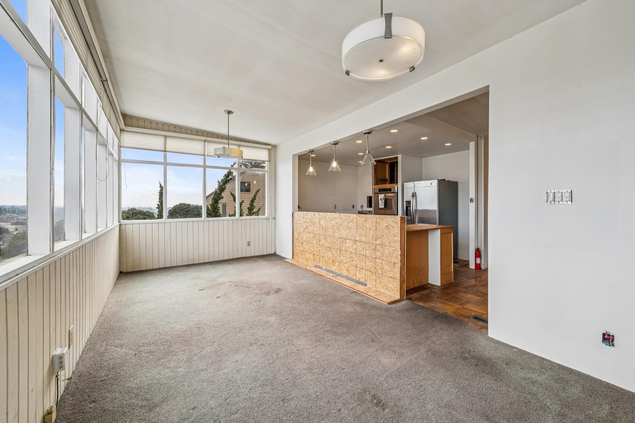 953 Hillside Avenue Albany, CA 94706 - Photo 12 of 48 a view of a big room with wooden floor and windows