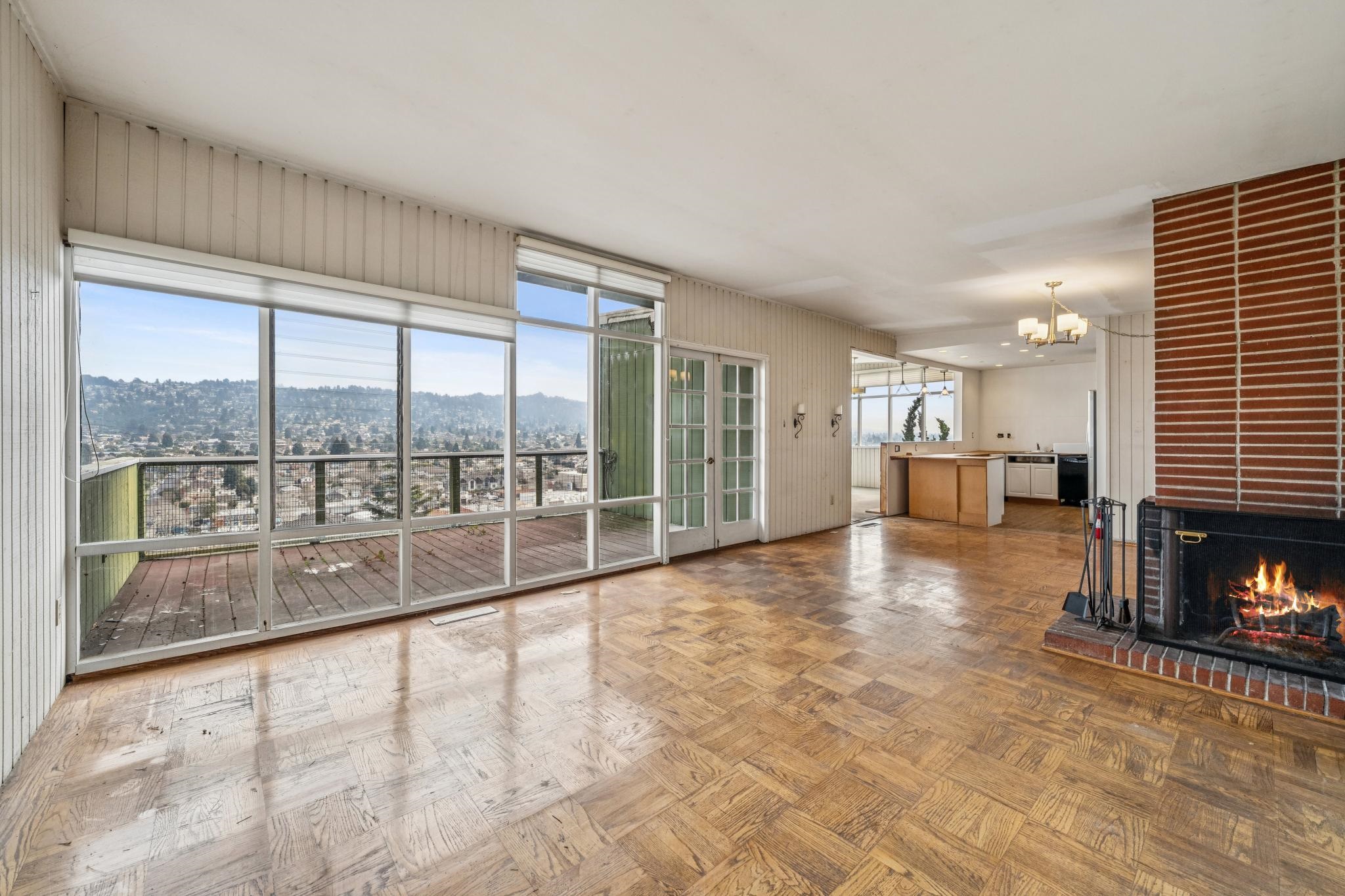 953 Hillside Avenue Albany, CA 94706 - Photo 22 of 48 a view of an empty room with a fireplace and a large window
