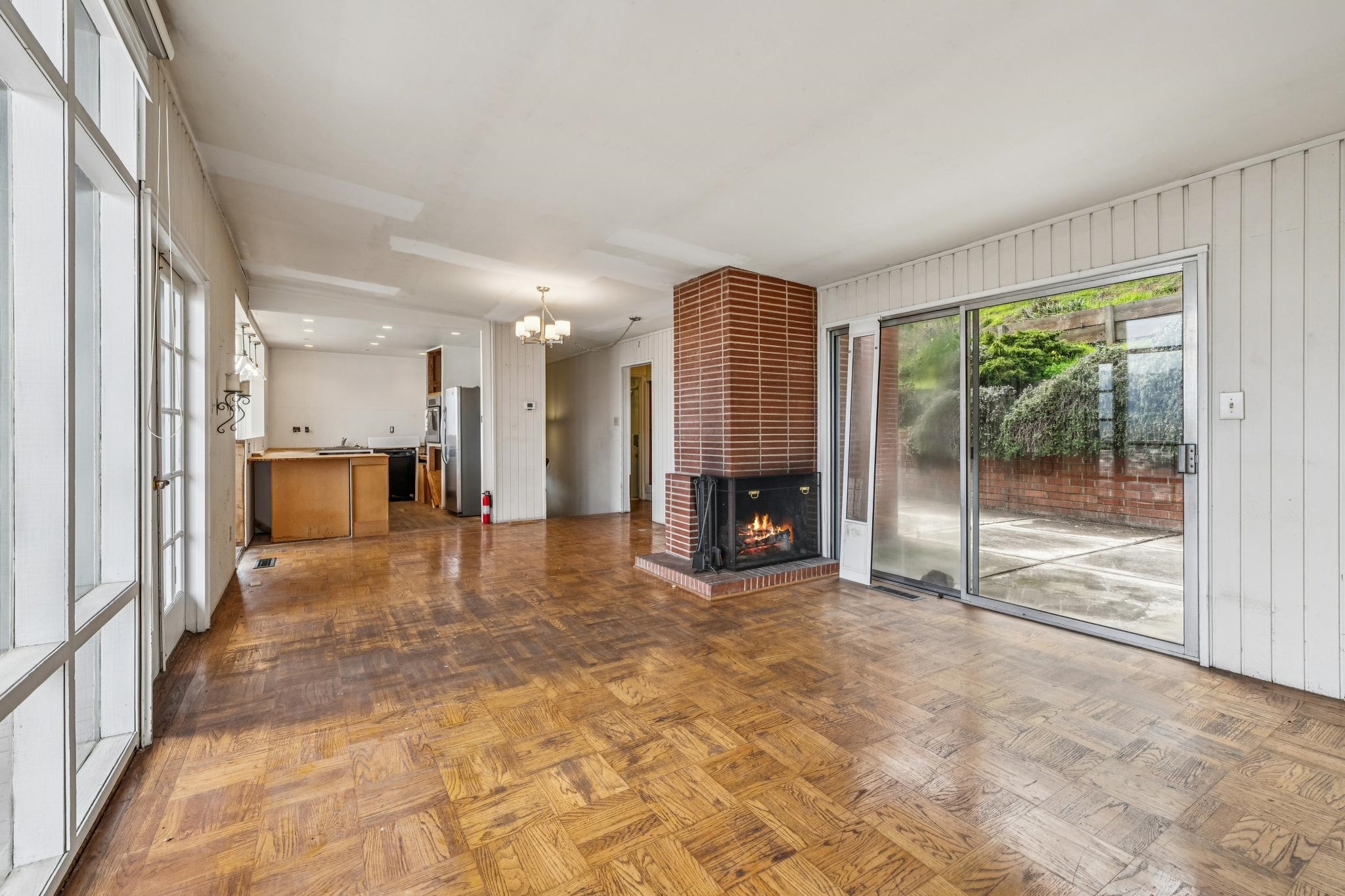 953 Hillside Avenue Albany, CA 94706 - Photo 23 of 48 a view of an empty room with a fireplace and a large window