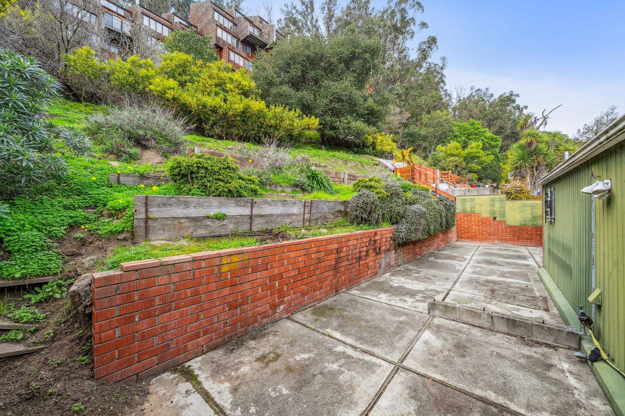 953 Hillside Avenue Albany, CA 94706 - Photo 30 of 48 a view of a pathway with a bench in front of it