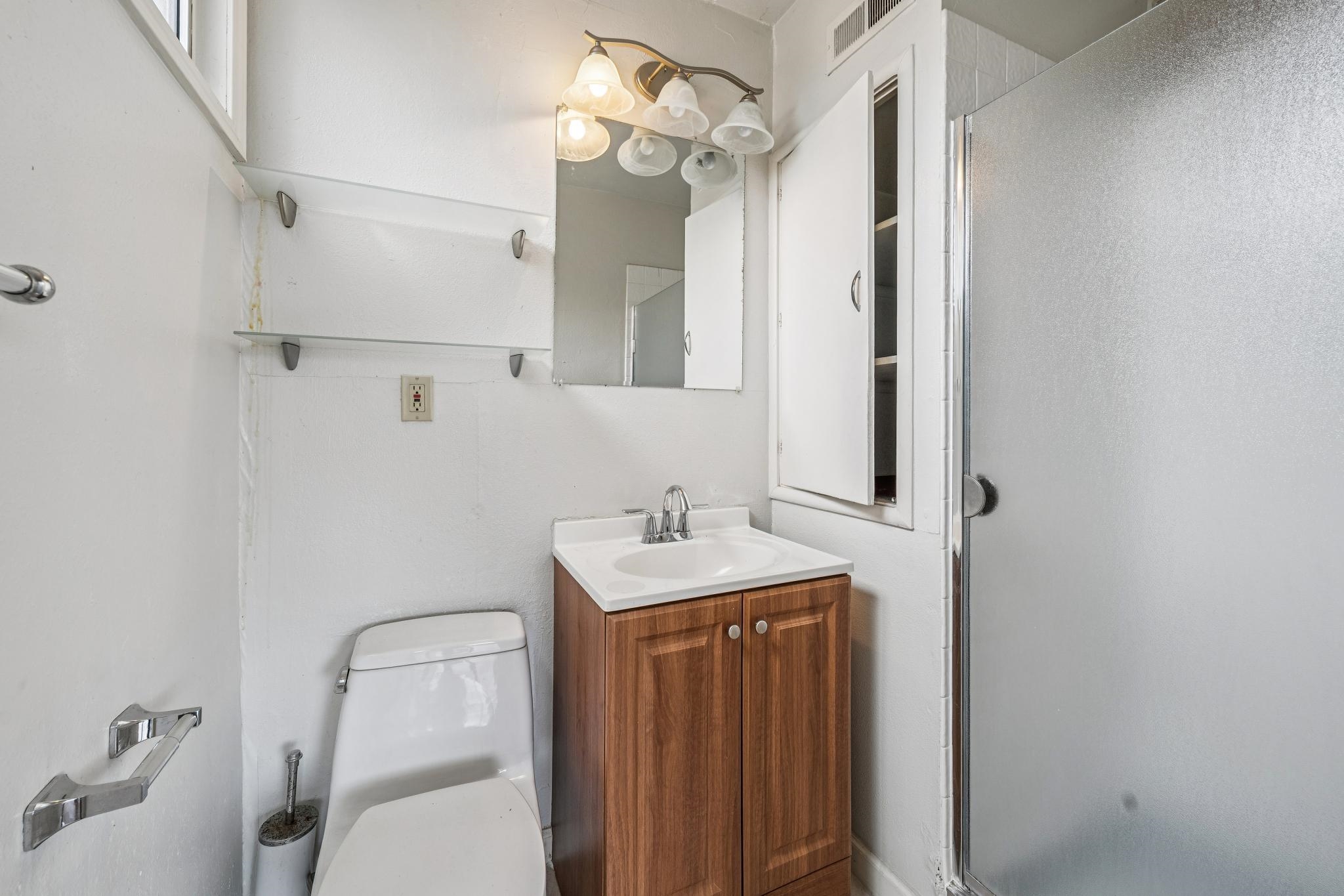 953 Hillside Avenue Albany, CA 94706 - Photo 39 of 48 a bathroom with a sink vanity mirror and toilet