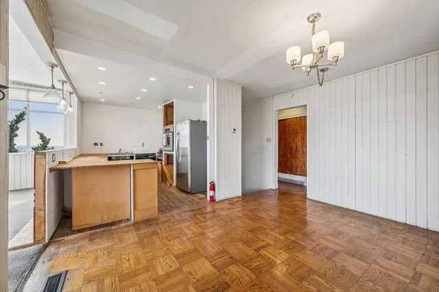 an empty room with windows and closet
