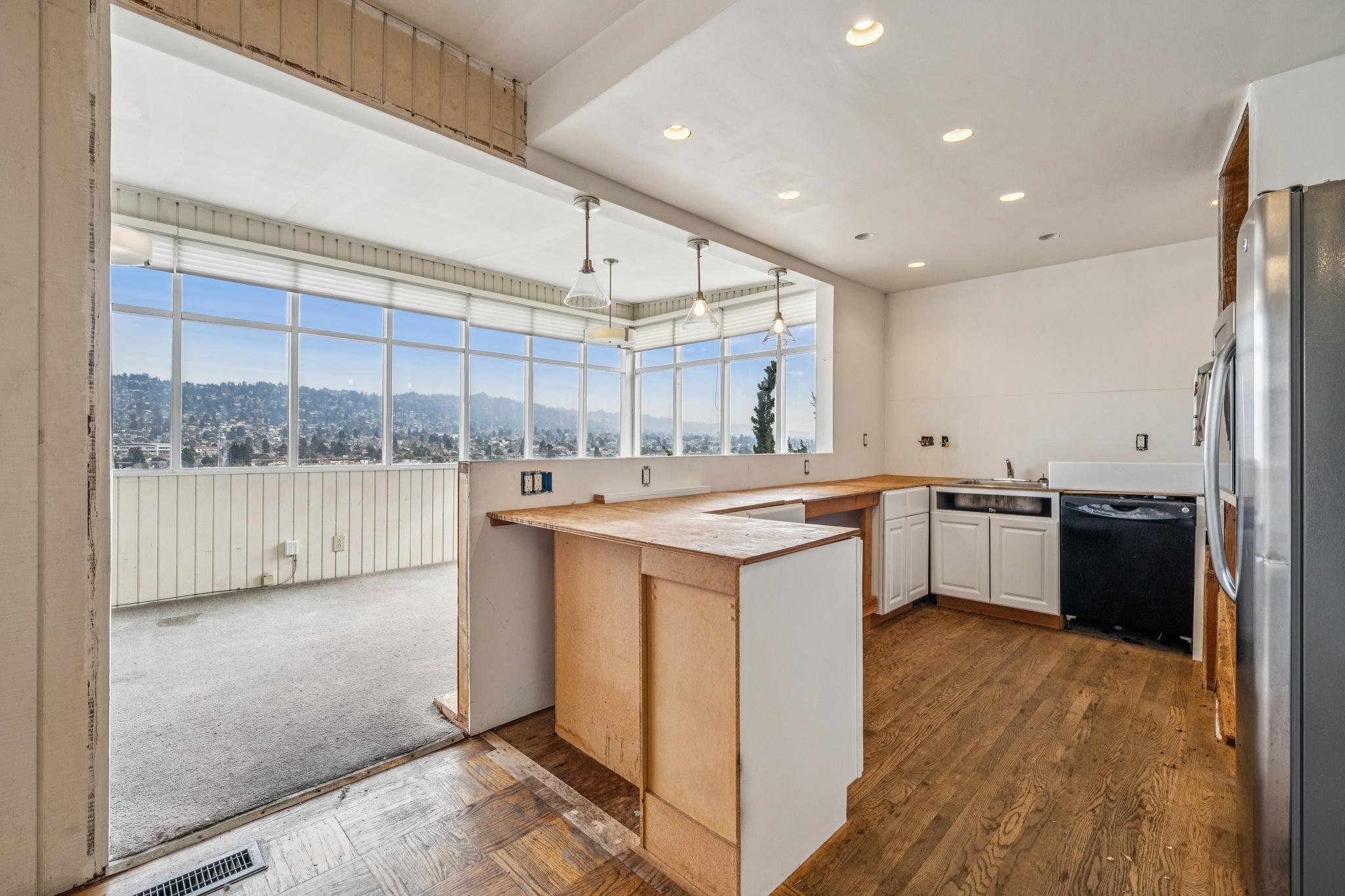 953 Hillside Avenue Albany, CA 94706 - Photo 7 of 48 a large kitchen with kitchen island a large counter space a sink and appliances