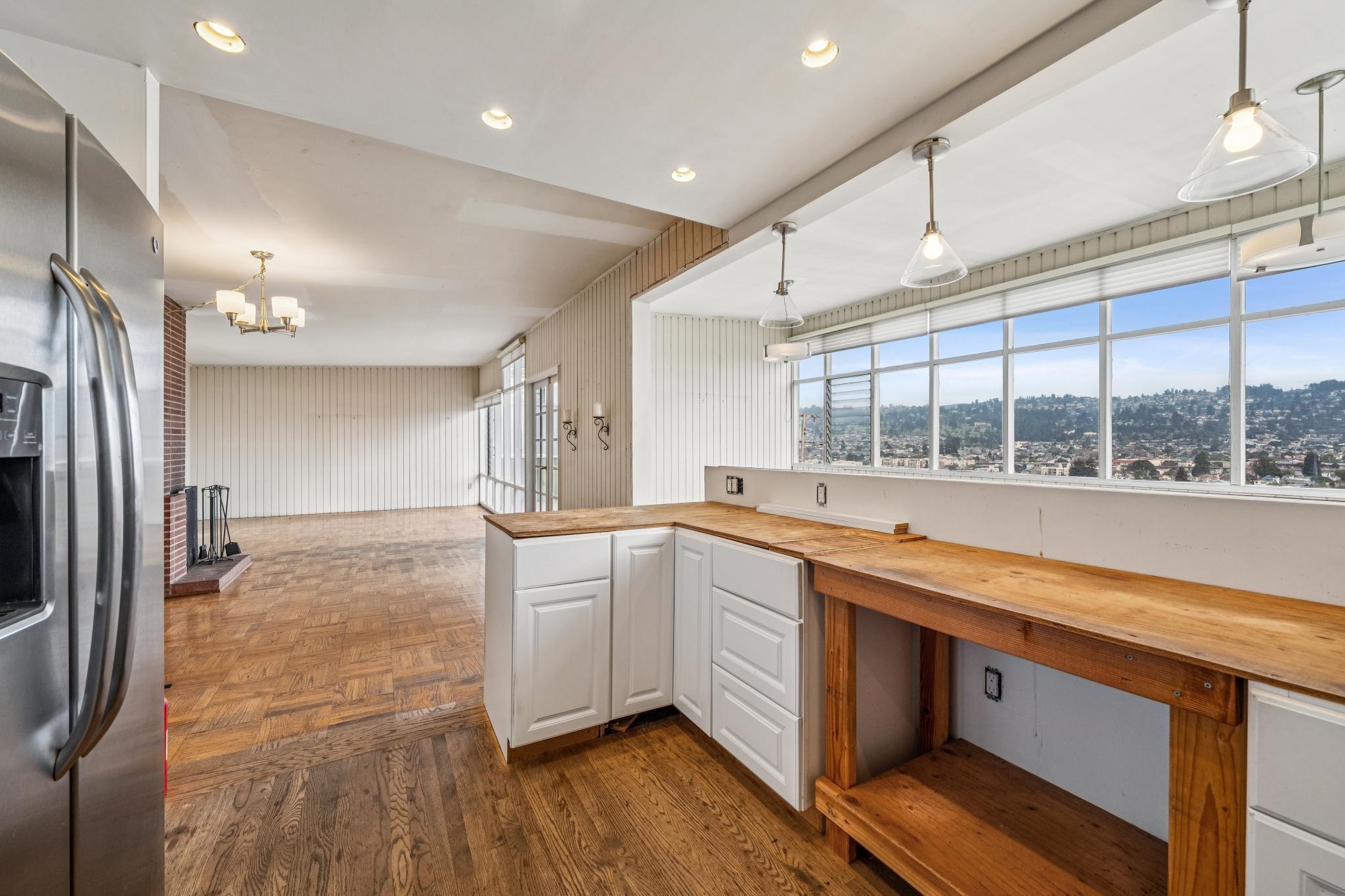 953 Hillside Avenue Albany, CA 94706 - Photo 8 of 48 a large kitchen with stainless steel appliances a large counter top a stove and a refrigerator