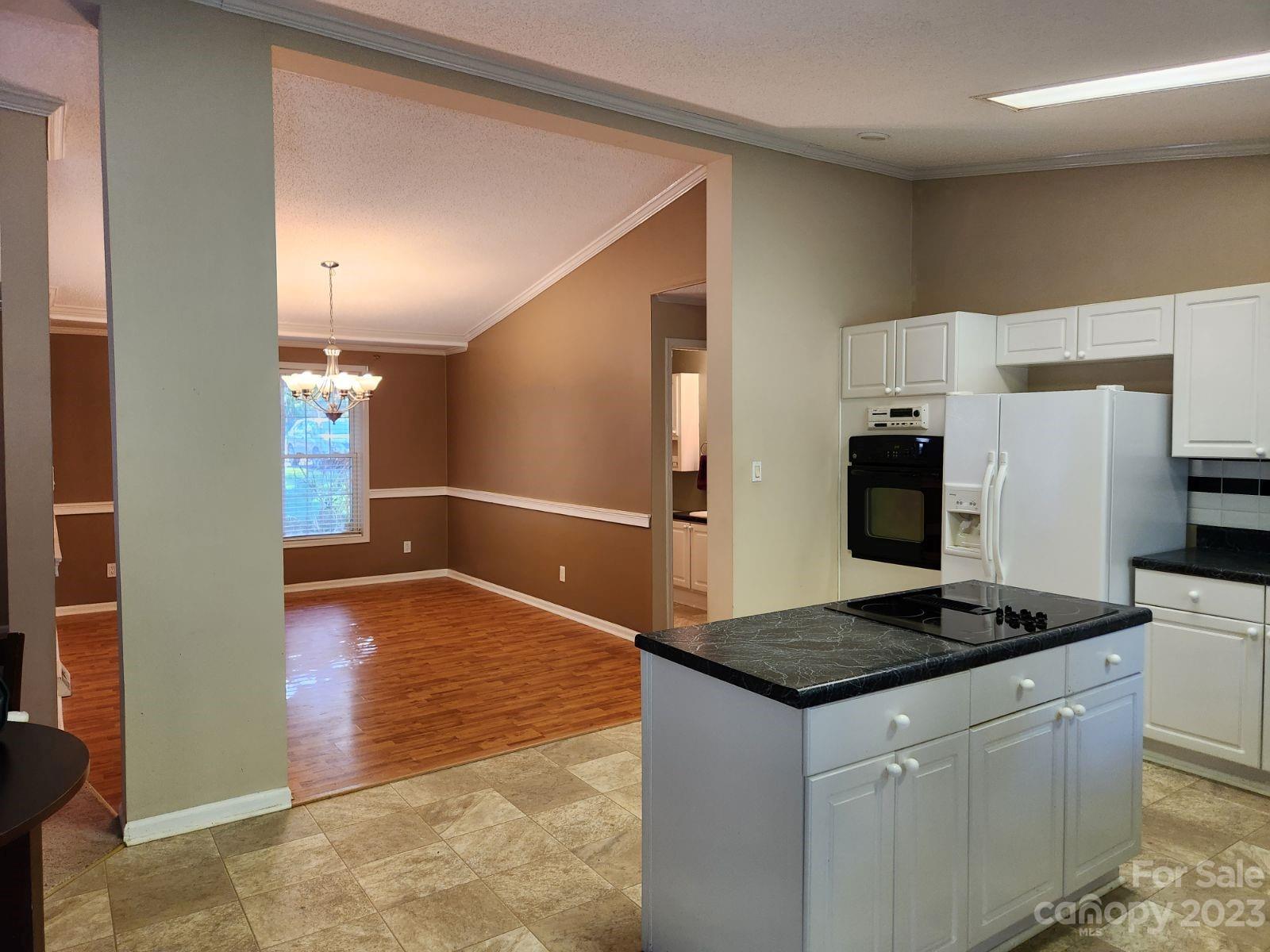 1952 Haire Road Fort Mill, SC 29715 - Photo 11 of 27 a kitchen with granite countertop a stove and a refrigerator