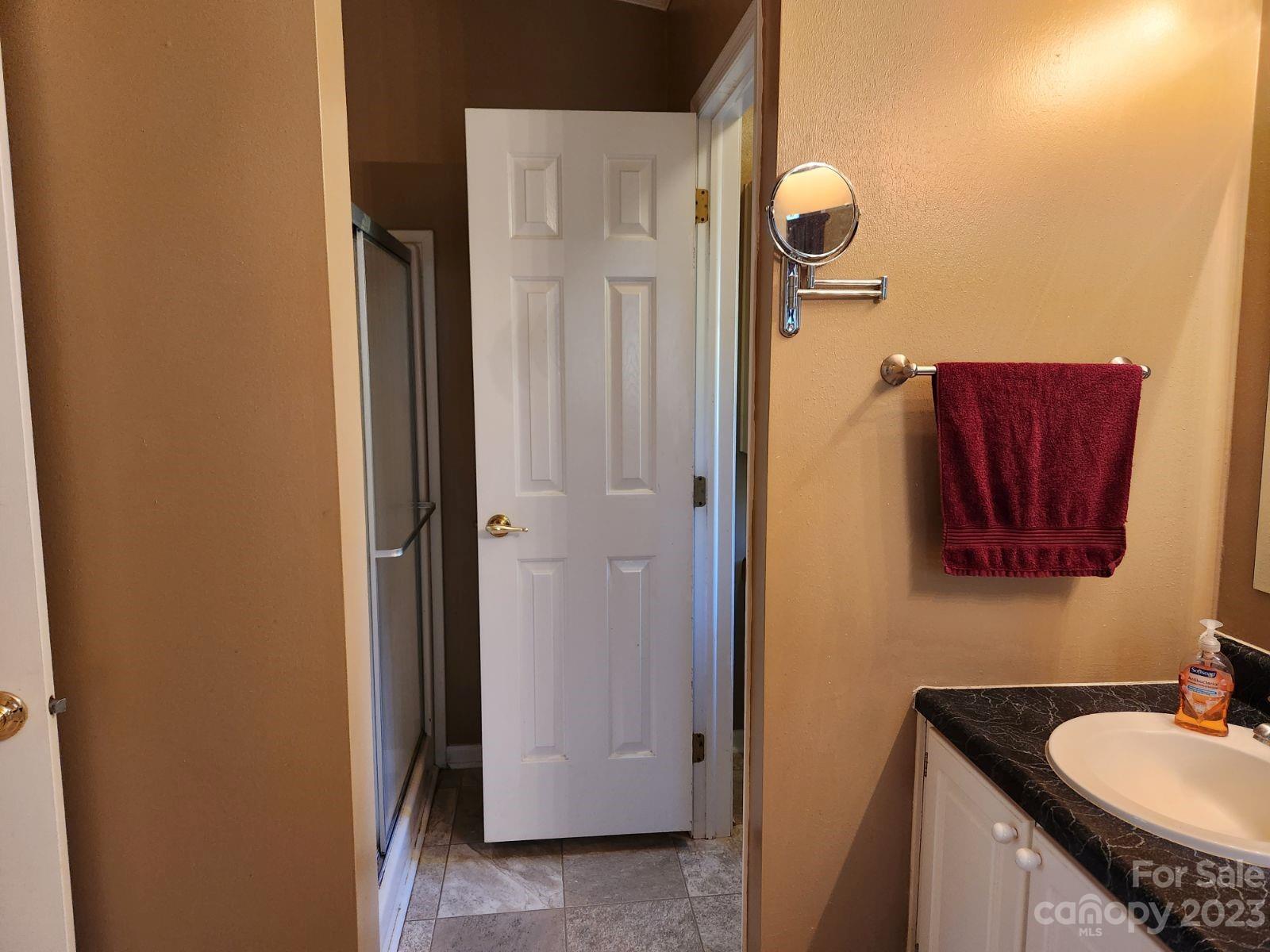 1952 Haire Road Fort Mill, SC 29715 - Photo 14 of 27 a bathroom with a granite countertop shower a mirror and a sink