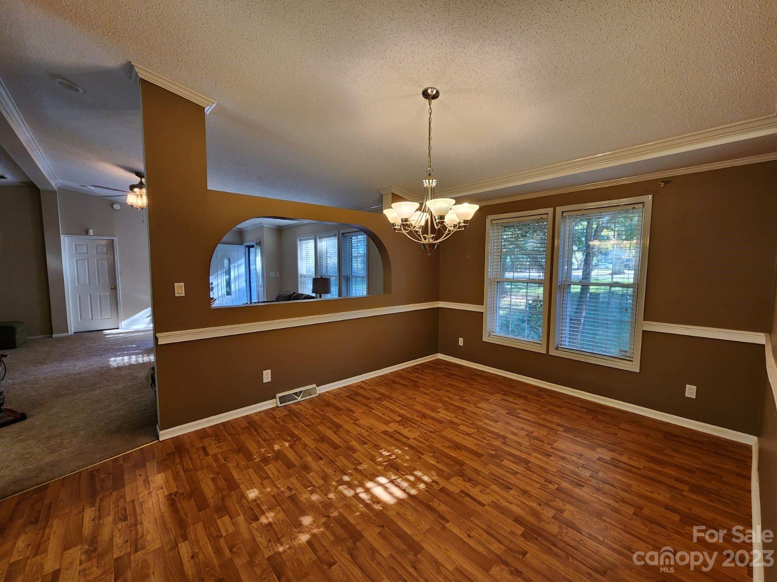 1952 Haire Road Fort Mill, SC 29715 - Photo 4 of 27 a view of a livingroom with a chandelier fan and wooden floor