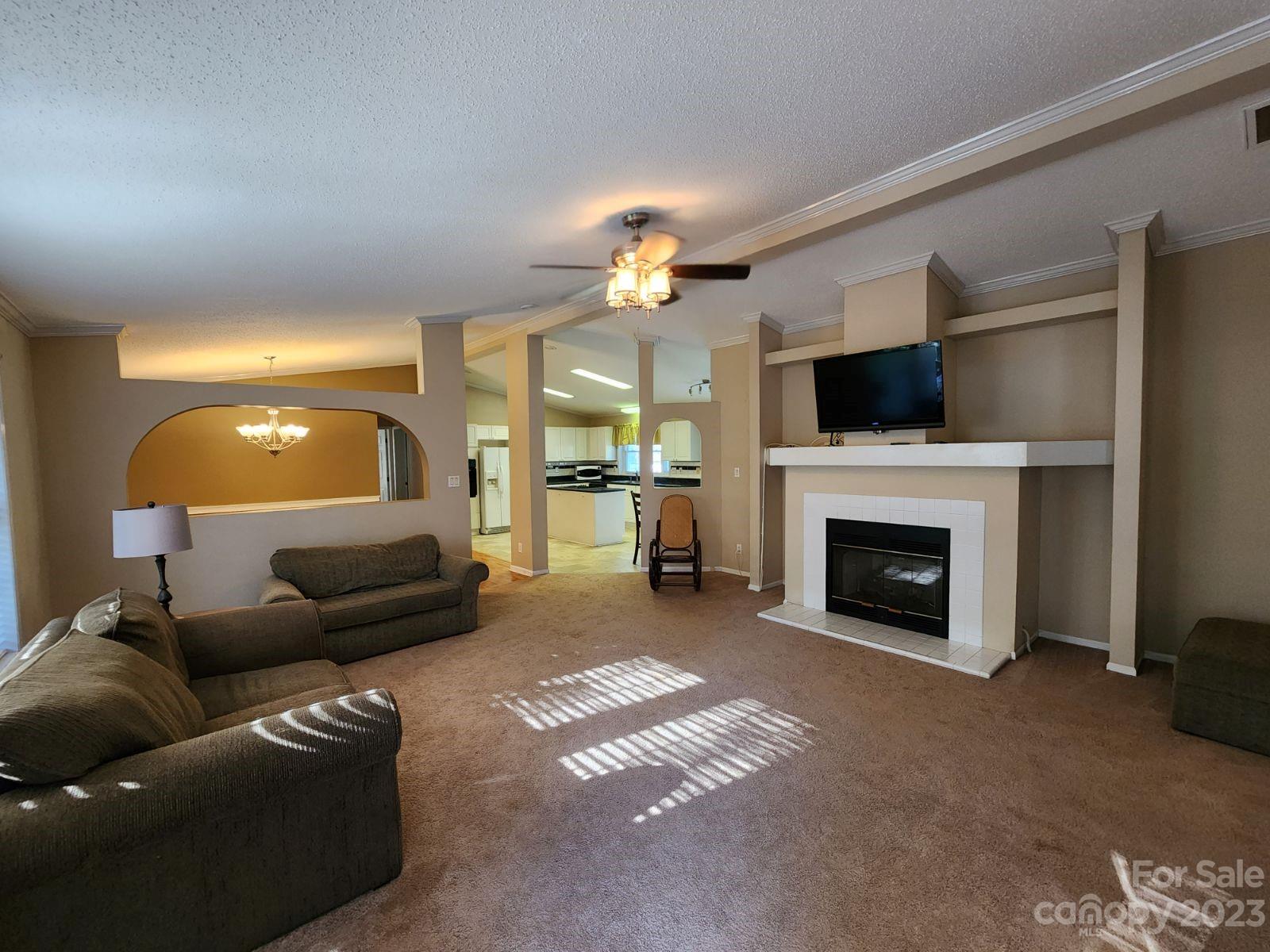 1952 Haire Road Fort Mill, SC 29715 - Photo 5 of 27 a living room with furniture a fireplace and a flat screen tv