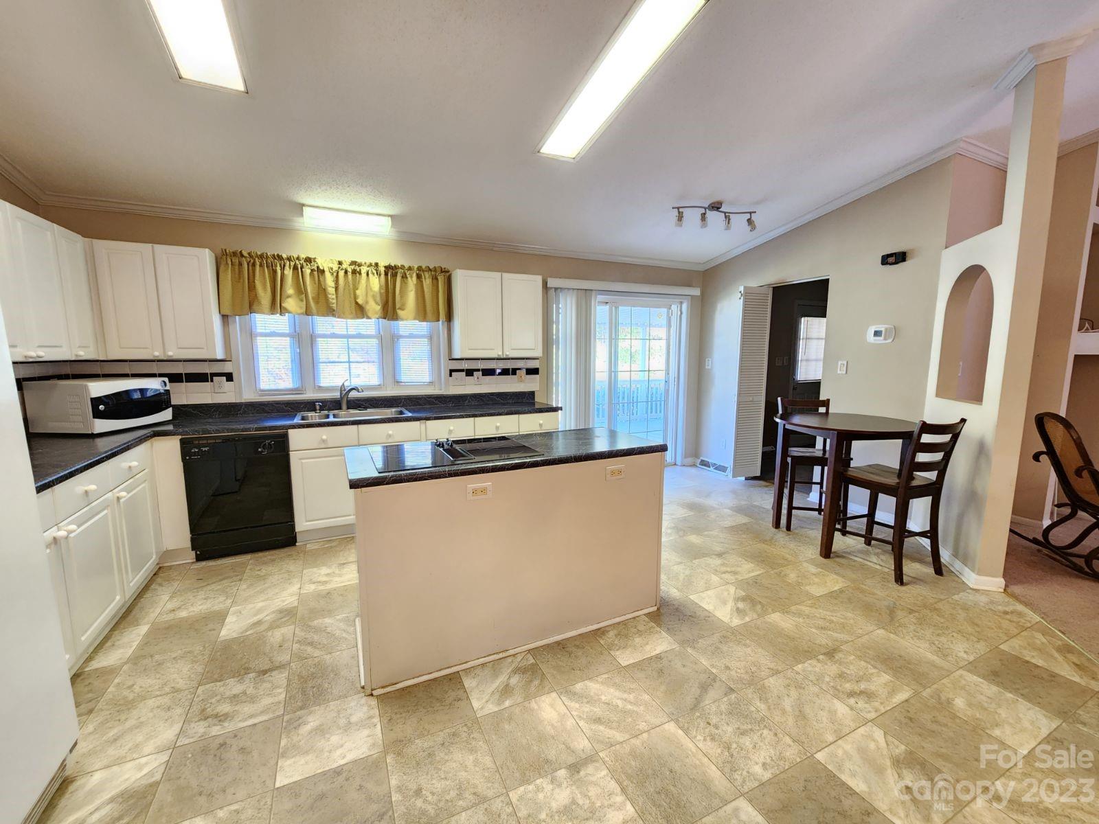 1952 Haire Road Fort Mill, SC 29715 - Photo 9 of 27 a kitchen with stainless steel appliances granite countertop a stove top oven a sink a dining table and chairs