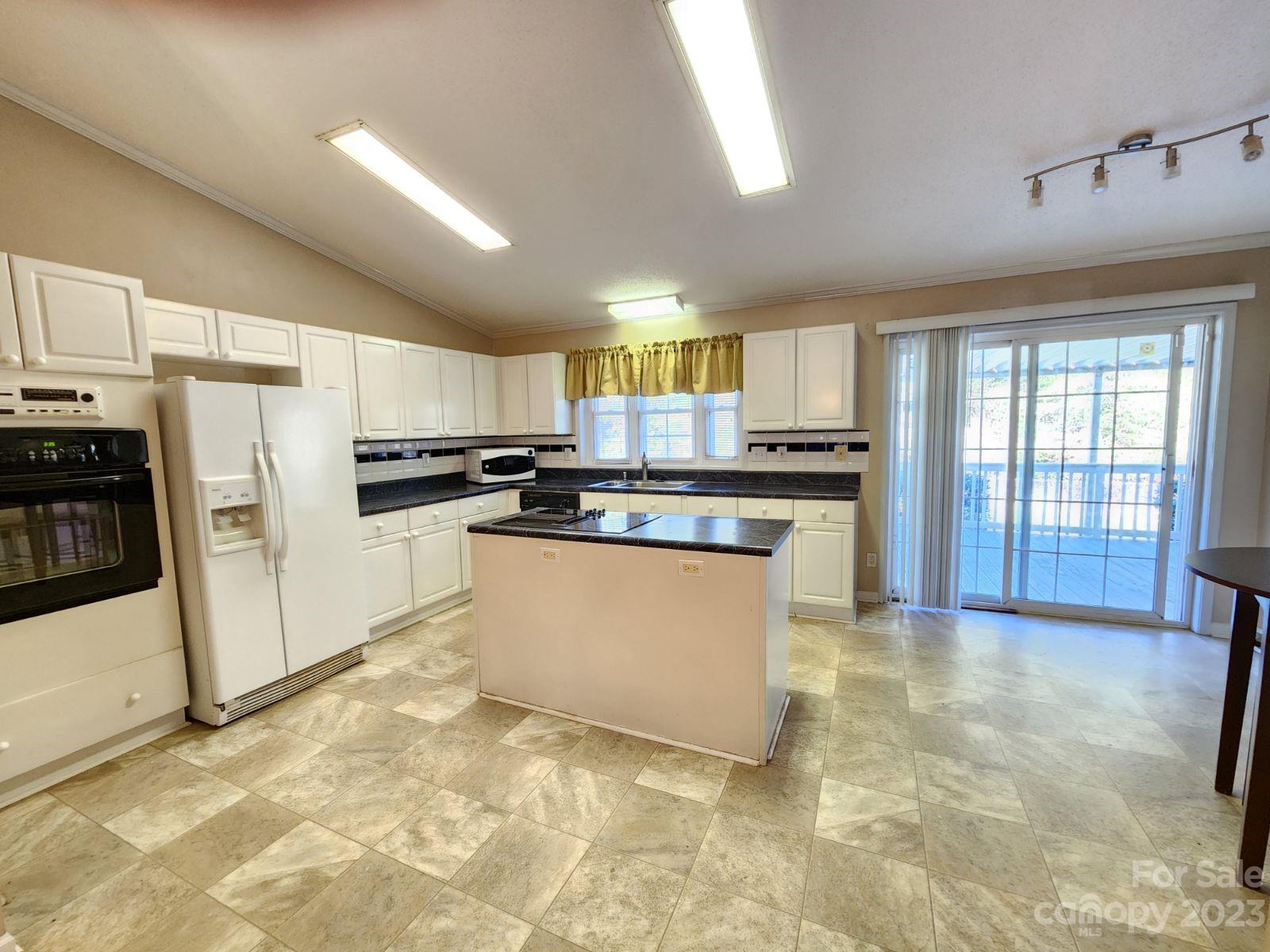 1952 Haire Road Fort Mill, SC 29715 - Photo 10 of 27 a kitchen with stainless steel appliances granite countertop a stove a sink dishwasher a refrigerator and a stove top oven with white cabinets