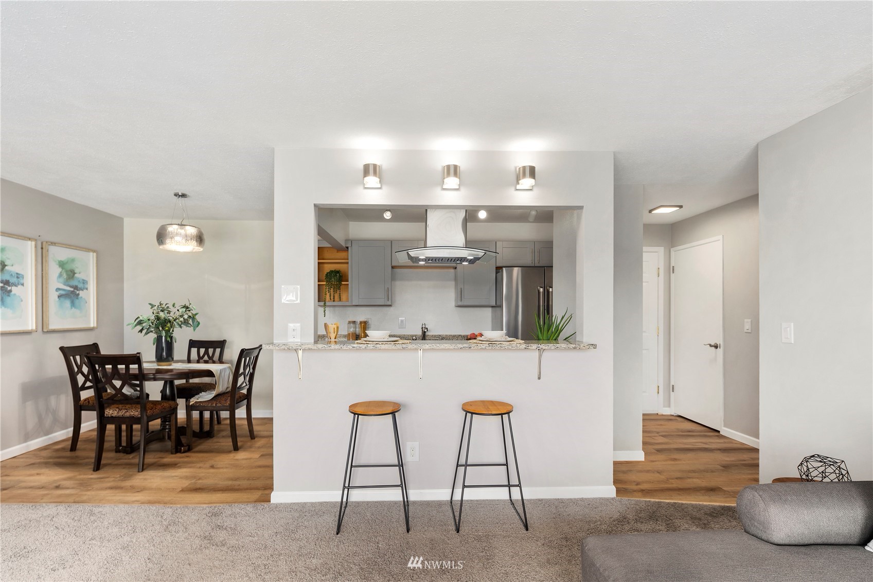 5021 Ripley Lane North, Unit 202 Renton, WA 98056 - Photo 16 of 35 a view of kitchen with kitchen island dining table and chairs
