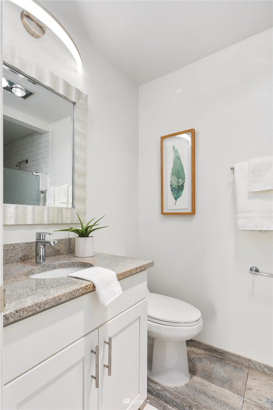 5021 Ripley Lane North, Unit 202 Renton, WA 98056 - Photo 23 of 35 a bathroom with a granite countertop toilet sink and mirror