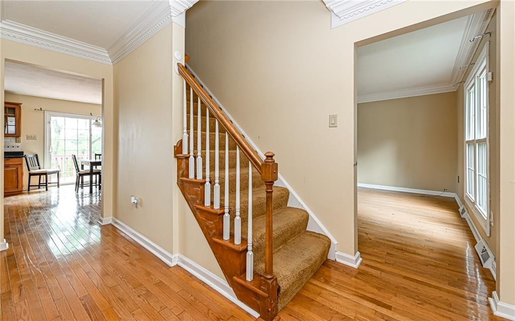 302 Ridgeway Drive Wexford, PA 15090 - Photo 16 of 28 a view of a hallway with wooden floor and staircase