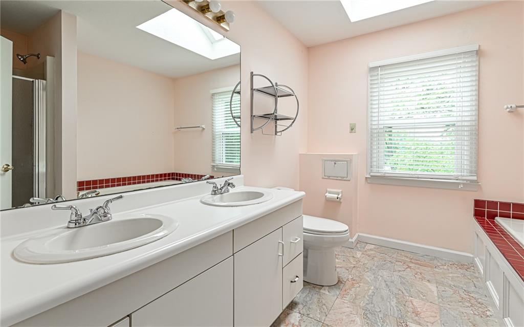 302 Ridgeway Drive Wexford, PA 15090 - Photo 19 of 28 a bathroom with a toilet a sink and a mirror