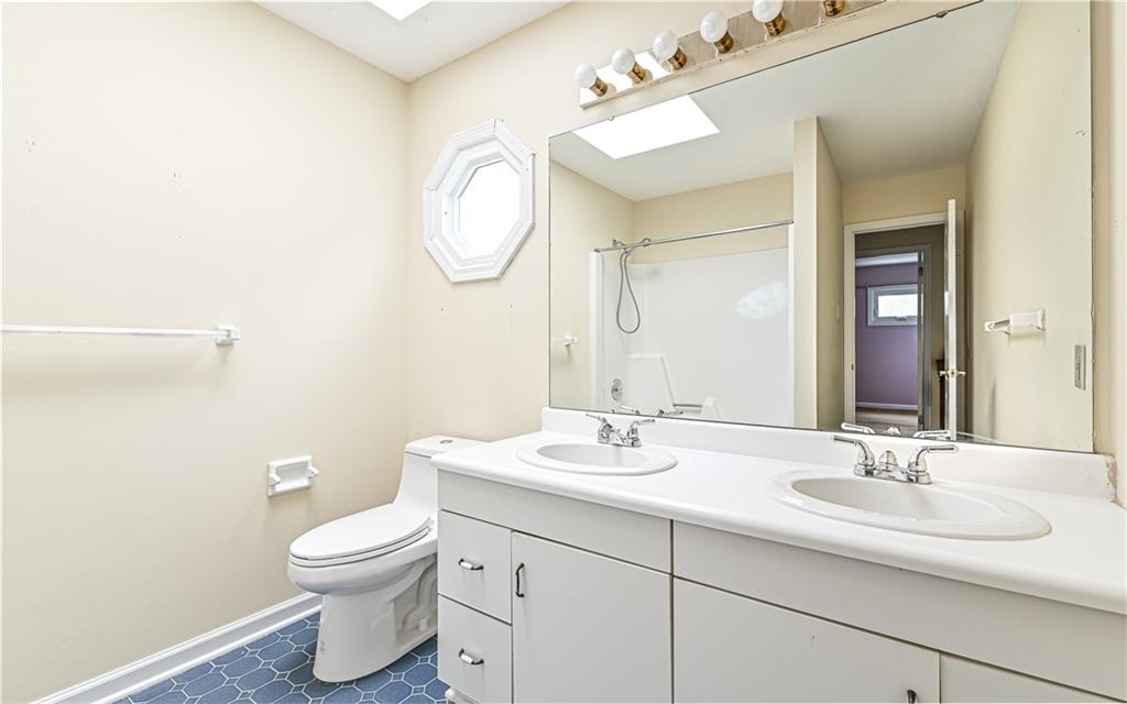 302 Ridgeway Drive Wexford, PA 15090 - Photo 20 of 28 a bathroom with a toilet sink and mirror