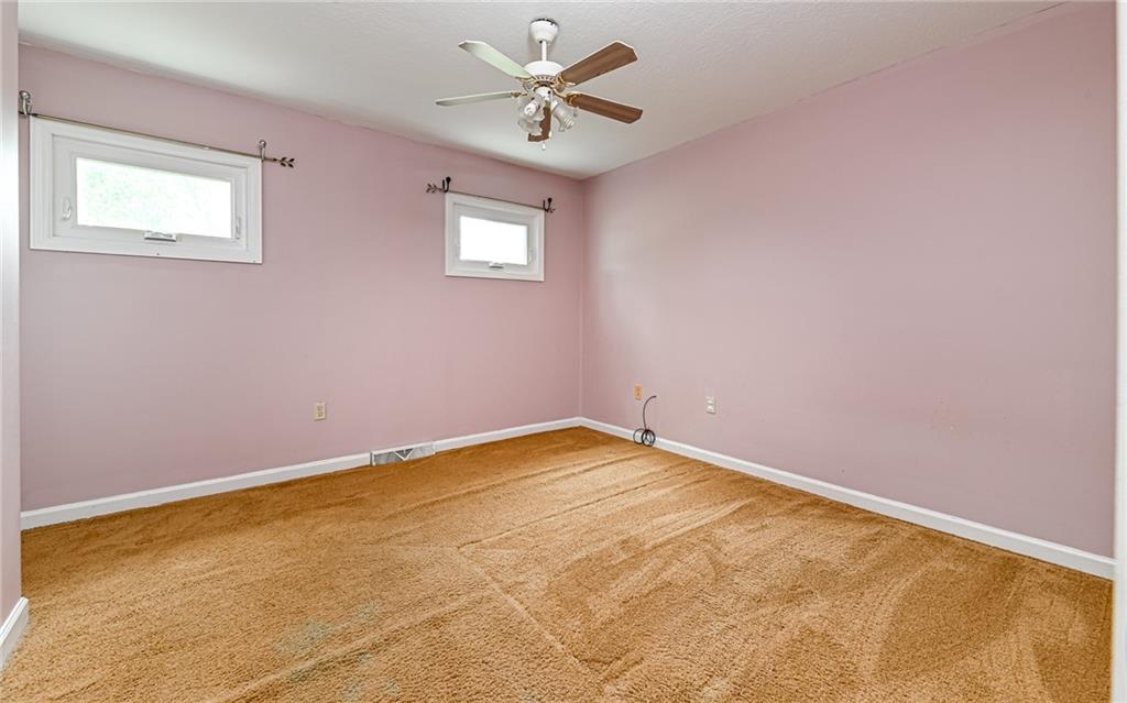 302 Ridgeway Drive Wexford, PA 15090 - Photo 24 of 28 an empty room with a window and a fan