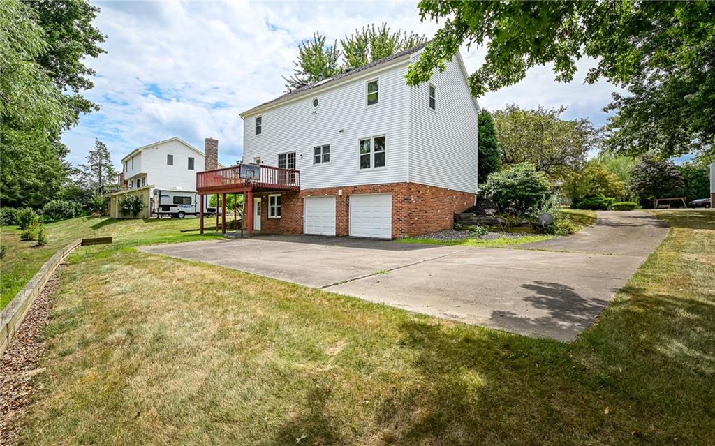 302 Ridgeway Drive Wexford, PA 15090 - Photo 27 of 28 a view of a white house with a big yard and large trees