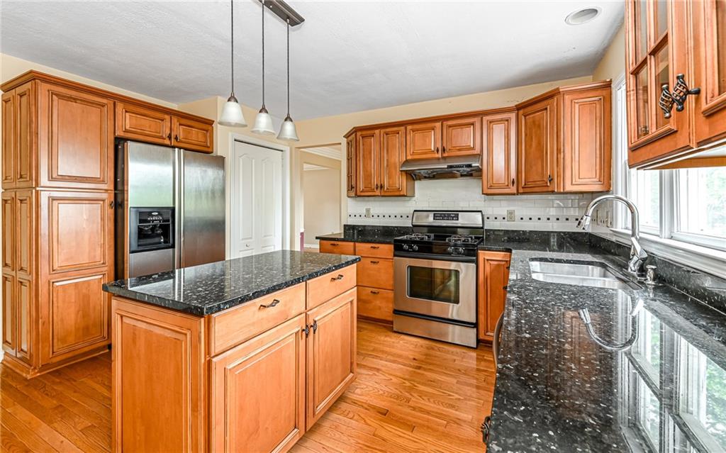 302 Ridgeway Drive Wexford, PA 15090 - Photo 3 of 28 a kitchen with stainless steel appliances granite countertop a sink stove and refrigerator