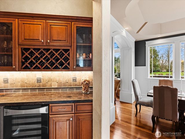 a kitchen with a sink cabinets and wooden floor