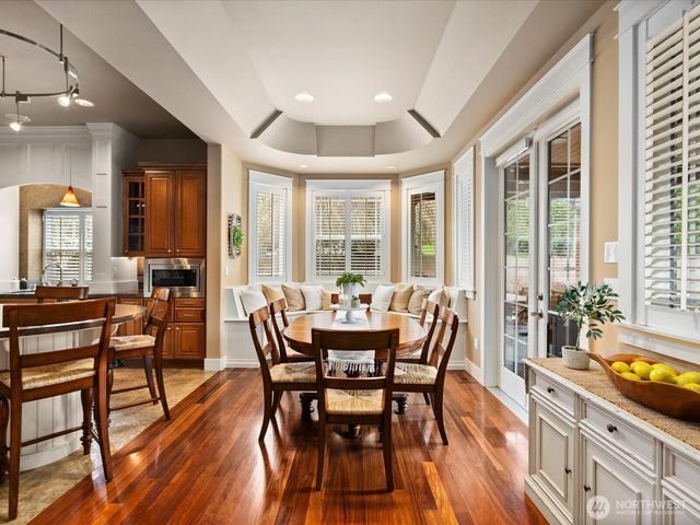 a dining room with furniture window and wooden floor
