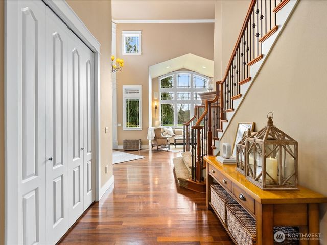 a view of entryway livingroom and hall with wooden floor