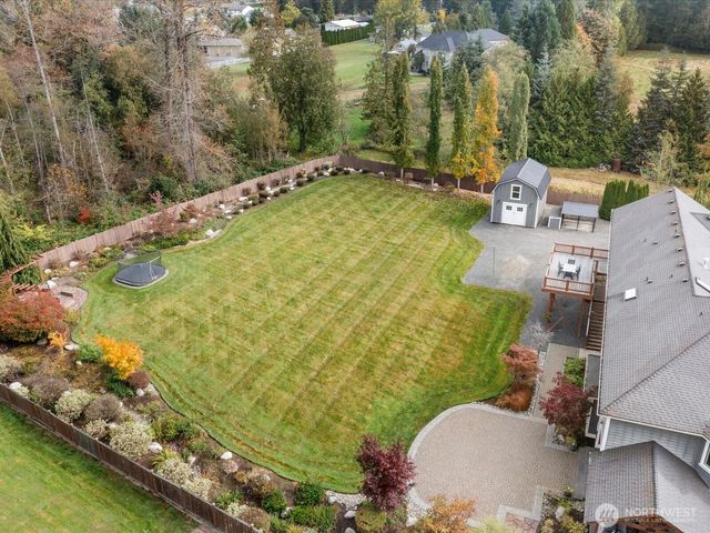 an aerial view of a residential houses with outdoor space