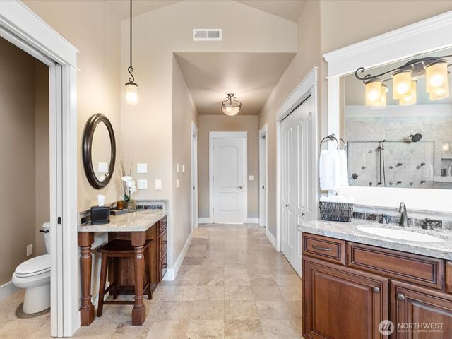 a bathroom with a sink a toilet and a mirror