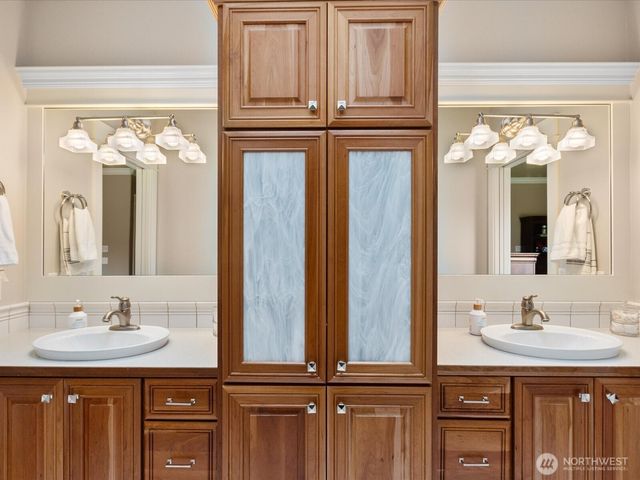 a bathroom with a sink a mirror and vanity