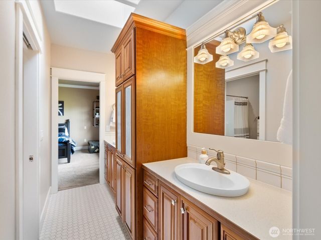 a en suite bathroom with a sink double vanity and mirror