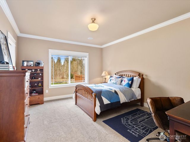 a bed sitting in a bedroom next to a window