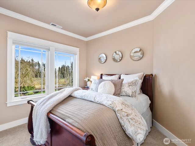a bedroom with a large bed and a window