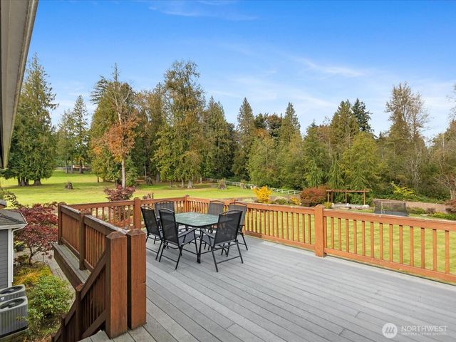 a view of a roof deck with furniture