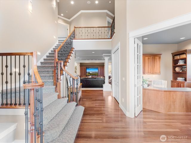 a view of a hallway view with wooden floor and staircase