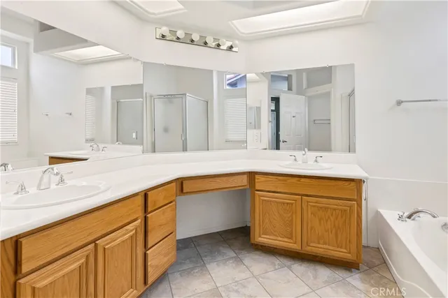 a bathroom with a granite countertop sink mirror and bathtub