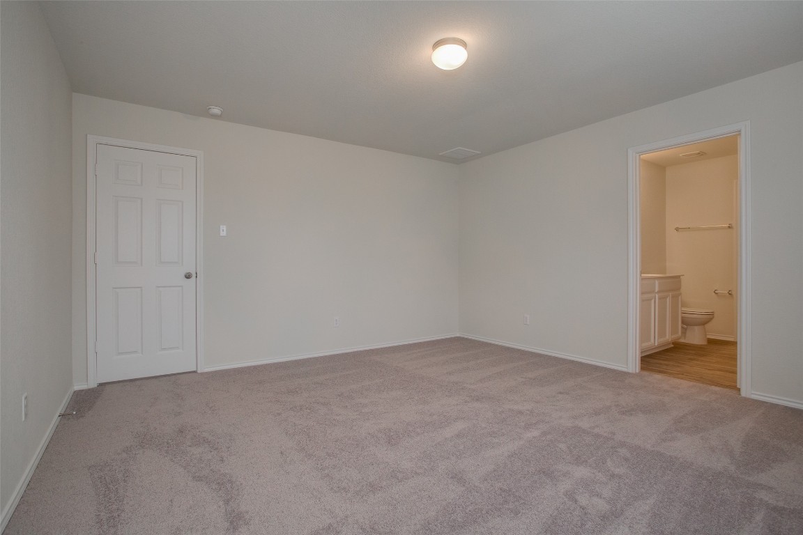 148 Spotted Rail Ridge Leander, TX 78641 - Photo 14 of 31 A spacious room featuring comfortable carpeting and convenient access to a private half bath.