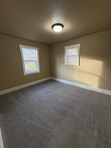 an empty room with a empty space and windows