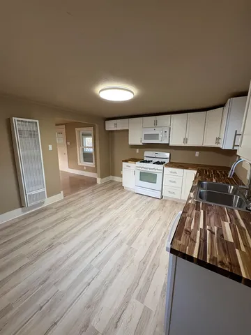 a kitchen with wooden floors and a stove