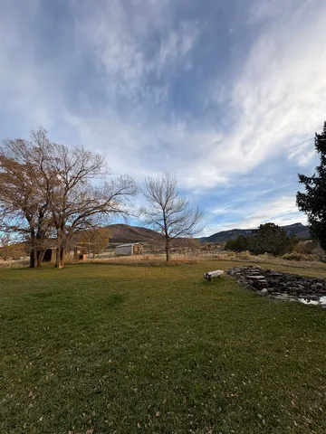 a view of yard with ocean and mountain in the background