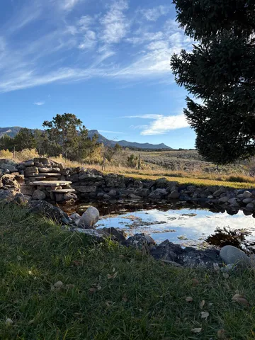 a view of a lake with green field
