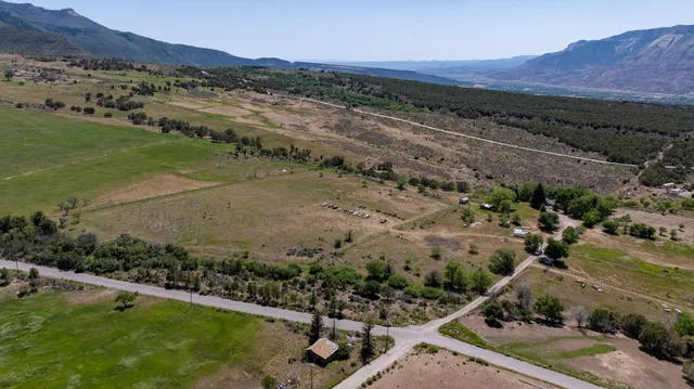 an aerial view of a house with a yard