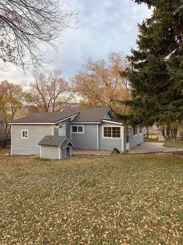 a house that has a tree in front of it