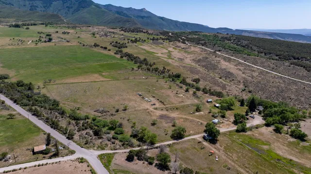 an aerial view of a house with a yard