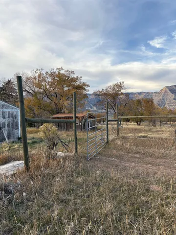 a view of a lake with a big yard and large trees