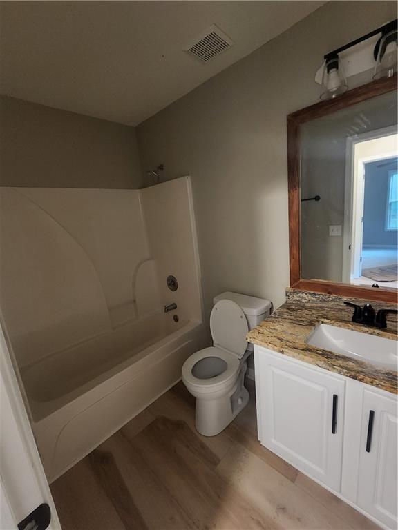 435 Butler Bridge Circle Covington, GA 30016 - Photo 18 of 25 a bathroom with a granite countertop toilet a sink and bathtub