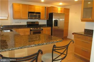 a kitchen with granite countertop a sink and a window