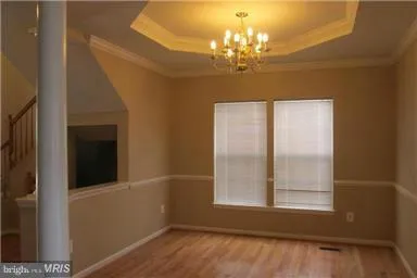 a view of a hallway with a chandelier and dining room view