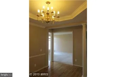 an empty room with windows and fireplace